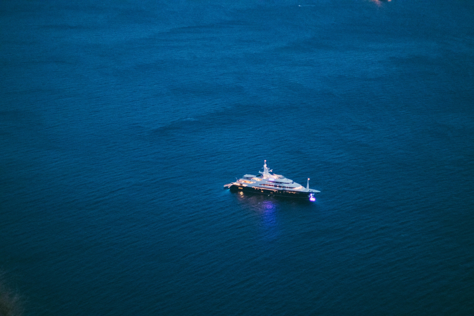Luxury yacht on deep blue ocean at dusk